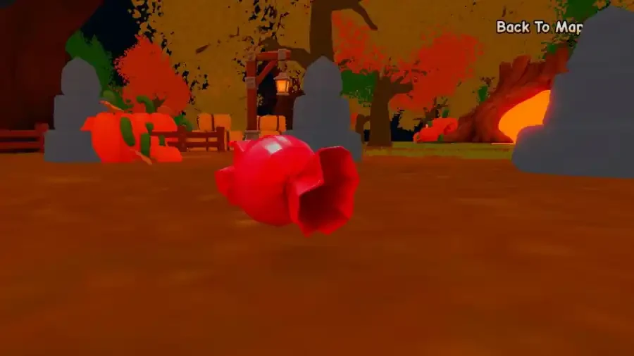 A red piece of candy lies on the ground in the Halloween World near the orange event portal.