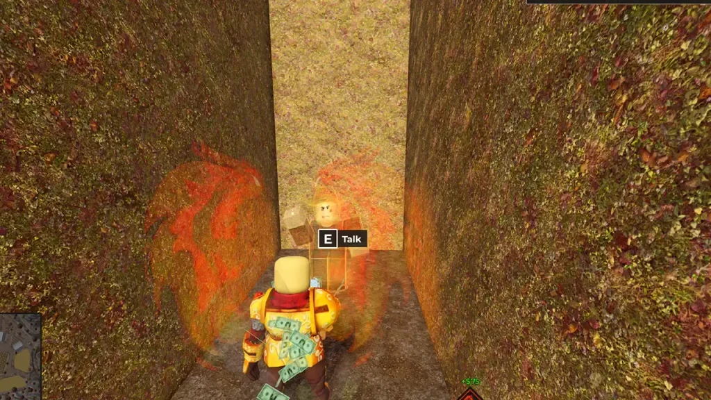 A glowing orange ghost with an E Talk prompt at the end of a maze corridor.